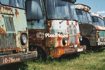 A row of abandoned and rusty Soviet-era trucks